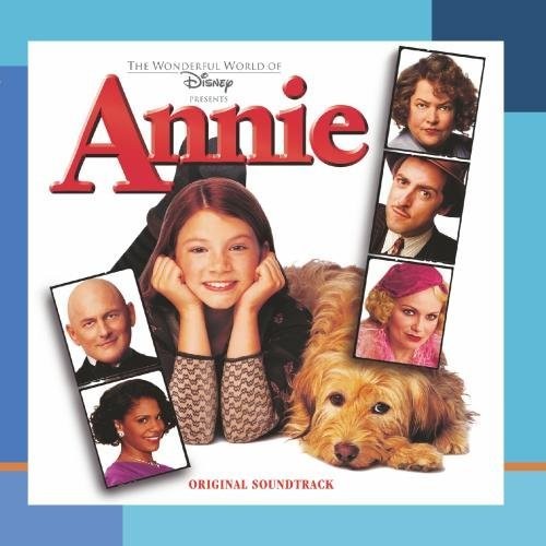 The album cover for the "Annie" soundtrack, featuring Annie in the center with small photo boxes featuring the other characters in the movie on either side of her.