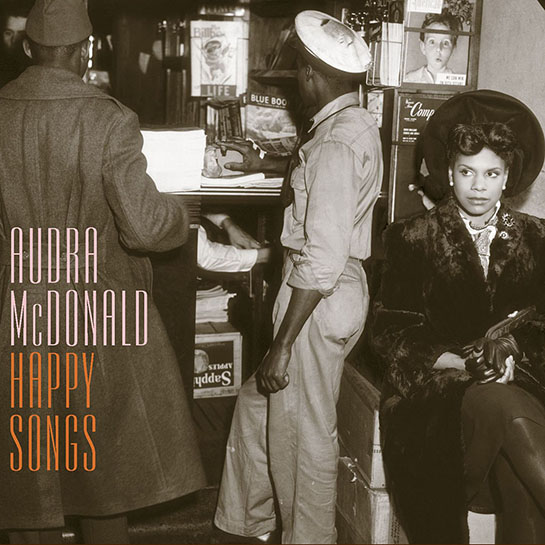The album cover for Audra McDonald's album "Happy Songs" featuring Audra in a 1920's style outfit sitting in front of a newstand.
